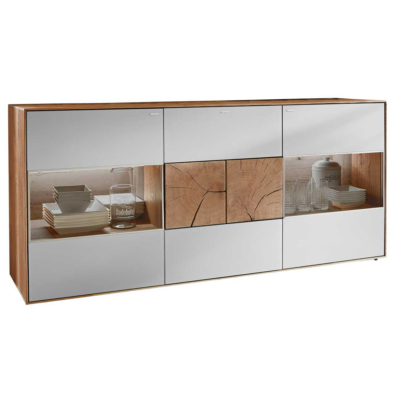 Hartmann CAYA - Sideboard 7170-4178W Modernes Sideboard aus massiver Kerneiche mit Mattglas weiß Fronten. Mit beleuchteten Glasausschnitten rechts und links und zwei rechteckigen Hirnholzscheiben in der Mitte.