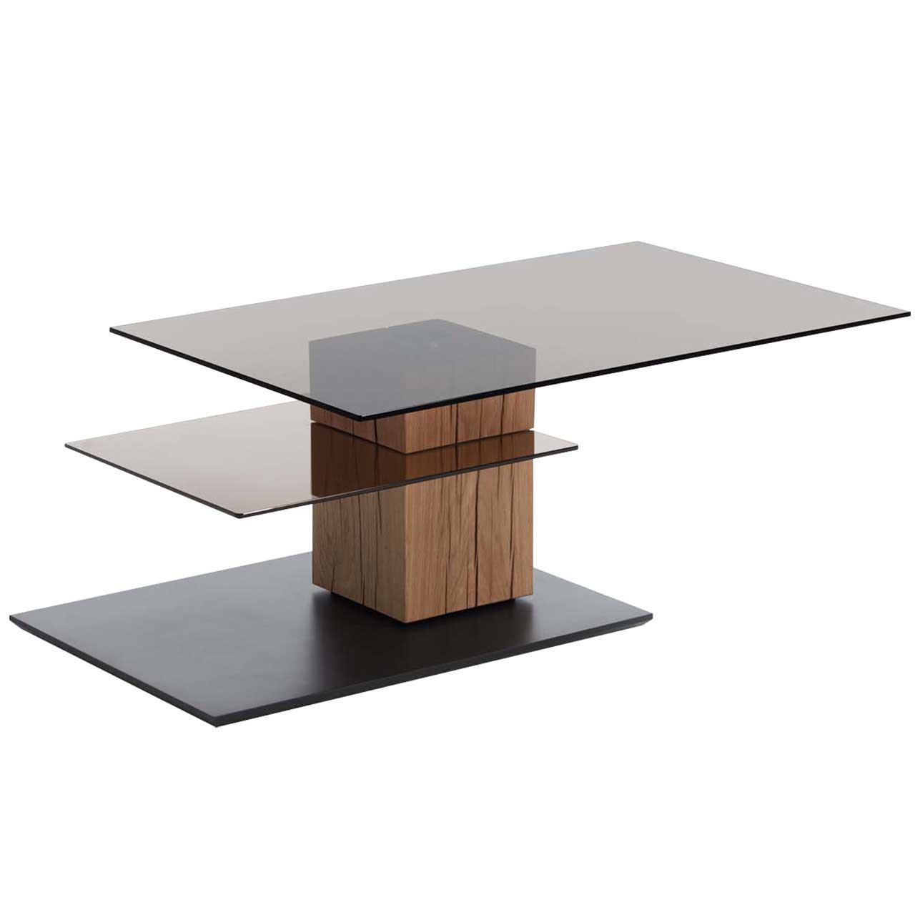 Edler Couchtisch mit drehbarer, rechteckiger Glasplatte und zusätzlicher fester Glasablage darunter. Massive Holzsäule aus Riffholz auf dunkler Bodenplatte.