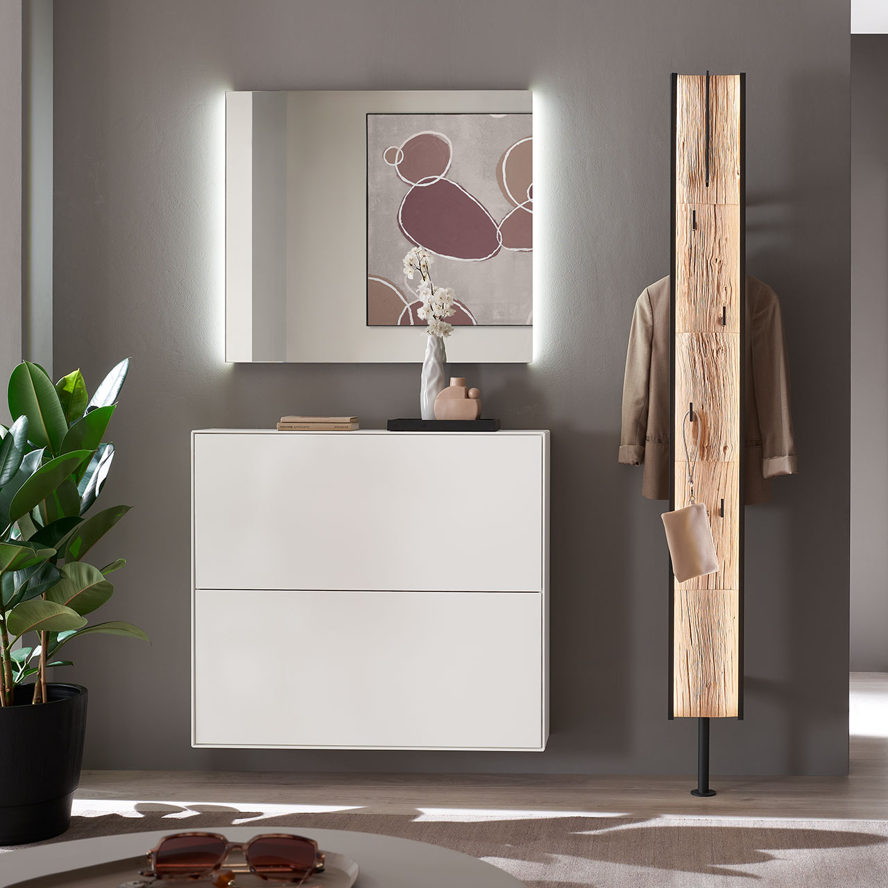 Hartmann SALVO 8550G - Garderobe Nr. V122S - dreiteilig - Kernbirke weiß Lack, Spaltholz Moderne dreiteilige Garderobe aus massiver Kernbirke weiß lackiert: Ein hängender Schuhkipper in Lack weiß, ein Garderobenpaneel mit Kleiderstange, Mantelhaken und Spaltholz-Akzent und ein rechteckiger Wandspiegel.